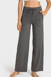 Gray wide-leg joggers with drawstring waist and utility pockets.