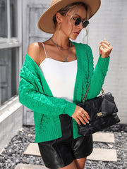 Green acrylic cable knit cardigan with open front and long sleeves.