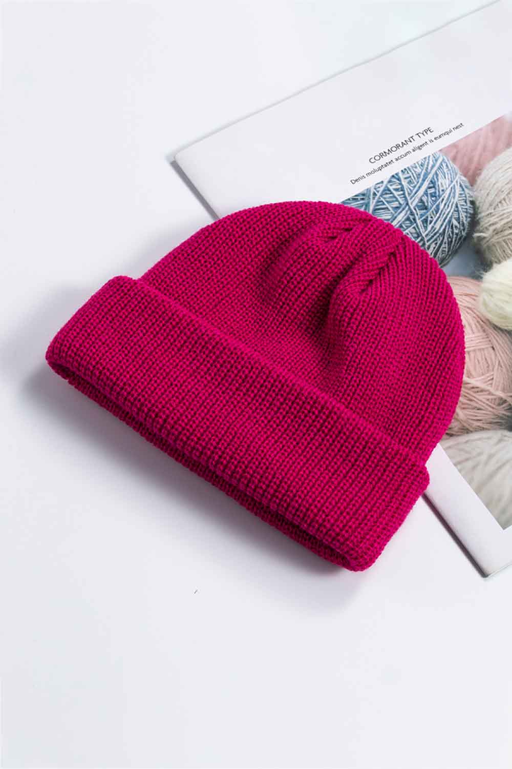 Ribbed knit beanie in magenta with a turned-up brim.