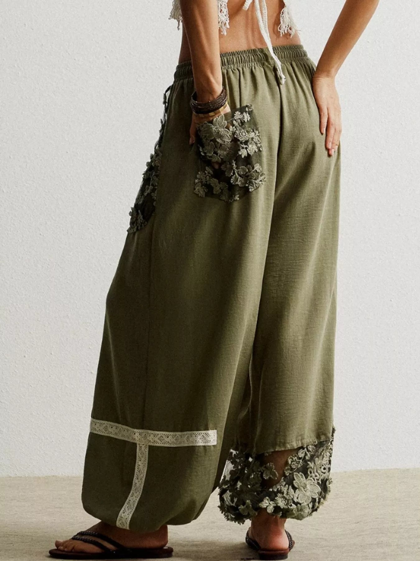 Moss drawstring harem pants with lace trim pockets and hem detail.
