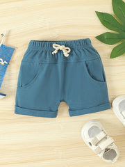 Sky blue cotton shorts with drawstring and cuffed hem.