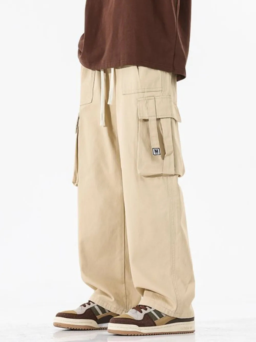 Khaki cotton wide-leg cargo sweatpants with drawstring waist and multiple pockets.