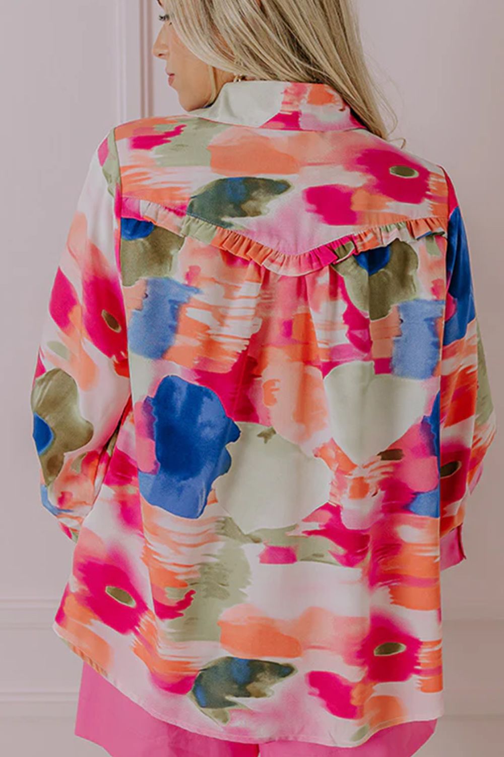 Painterly abstract print blouse in pink with ruffle detail on the back yoke.