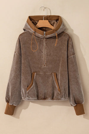 Brown corduroy half-zip hoodie with voluminous sleeves and a front pocket.