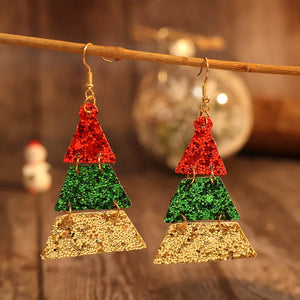 Festive glitter tiered Christmas tree earrings in red, green, and gold.