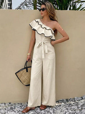 Elegant cream one-shoulder romper with ruffled trim and belted waist.