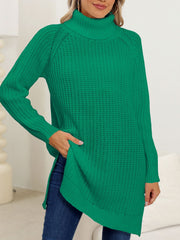 Dark green knit turtleneck sweater with an asymmetric hemline and side slits.