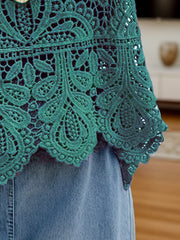 Turquoise lace overlay cropped vest with intricate floral pattern and scalloped hem.