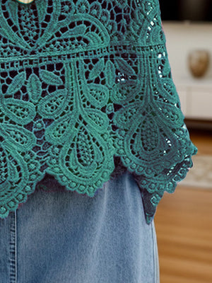 Turquoise lace overlay cropped vest with intricate floral pattern and scalloped hem.