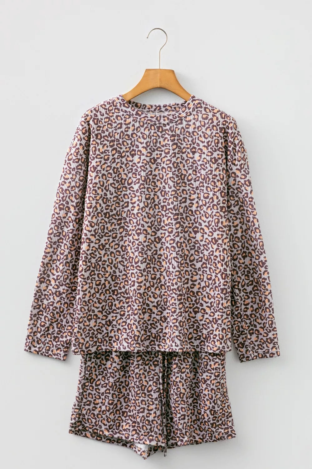 Leopard print ribbed loungewear set with long sleeve top and drawstring shorts.