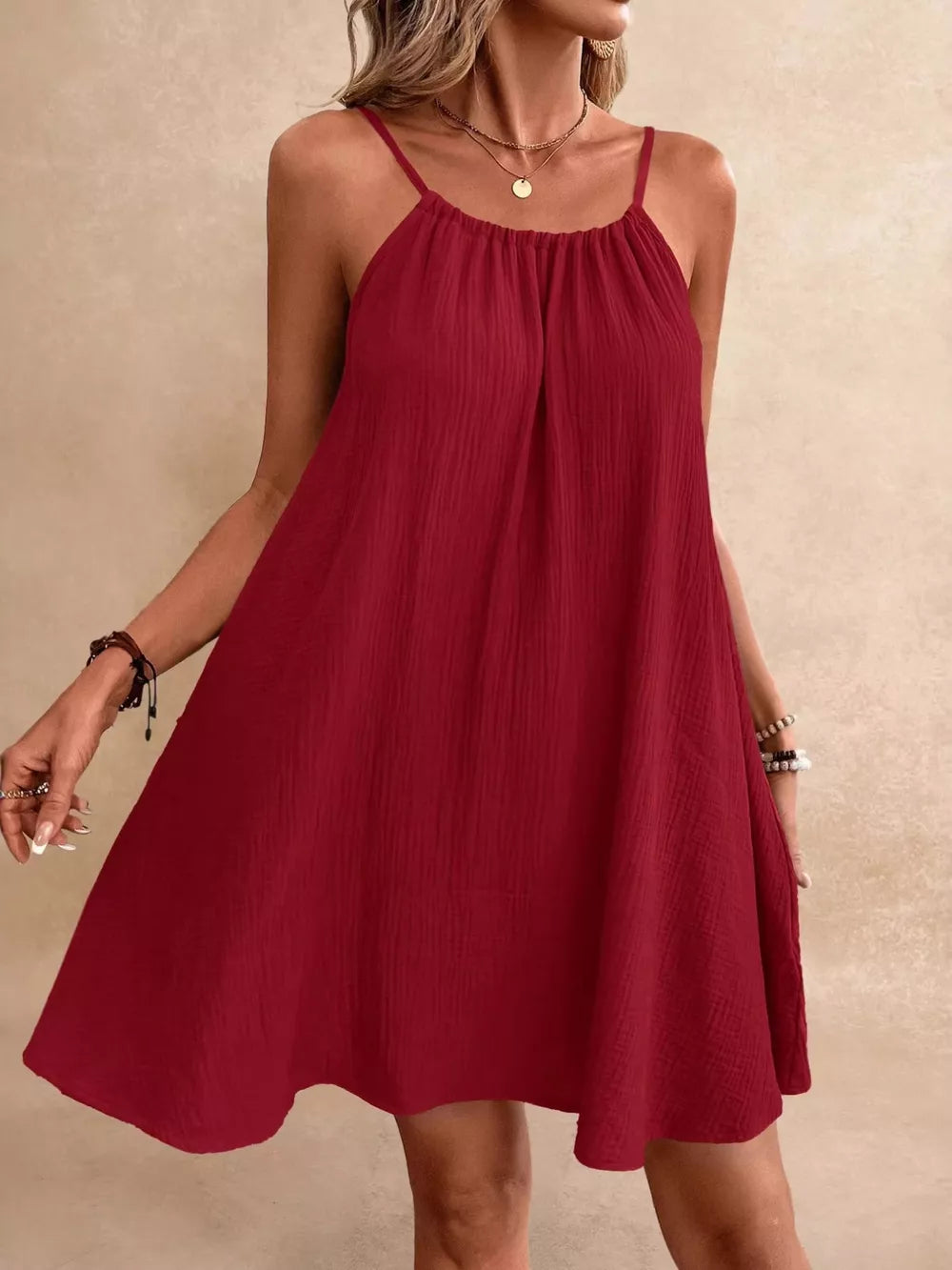 Scarlet spaghetti strap mini dress with gathered neckline and A-line skirt.