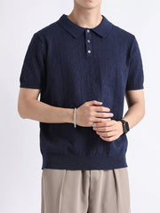 Navy short-sleeve polo shirt with textured fabric and button detail