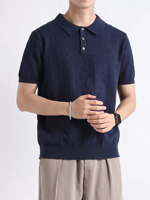 Navy short-sleeve polo shirt with textured fabric and button detail