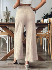 Textured gauze palazzo trousers in tan with wide legs and elastic waist.