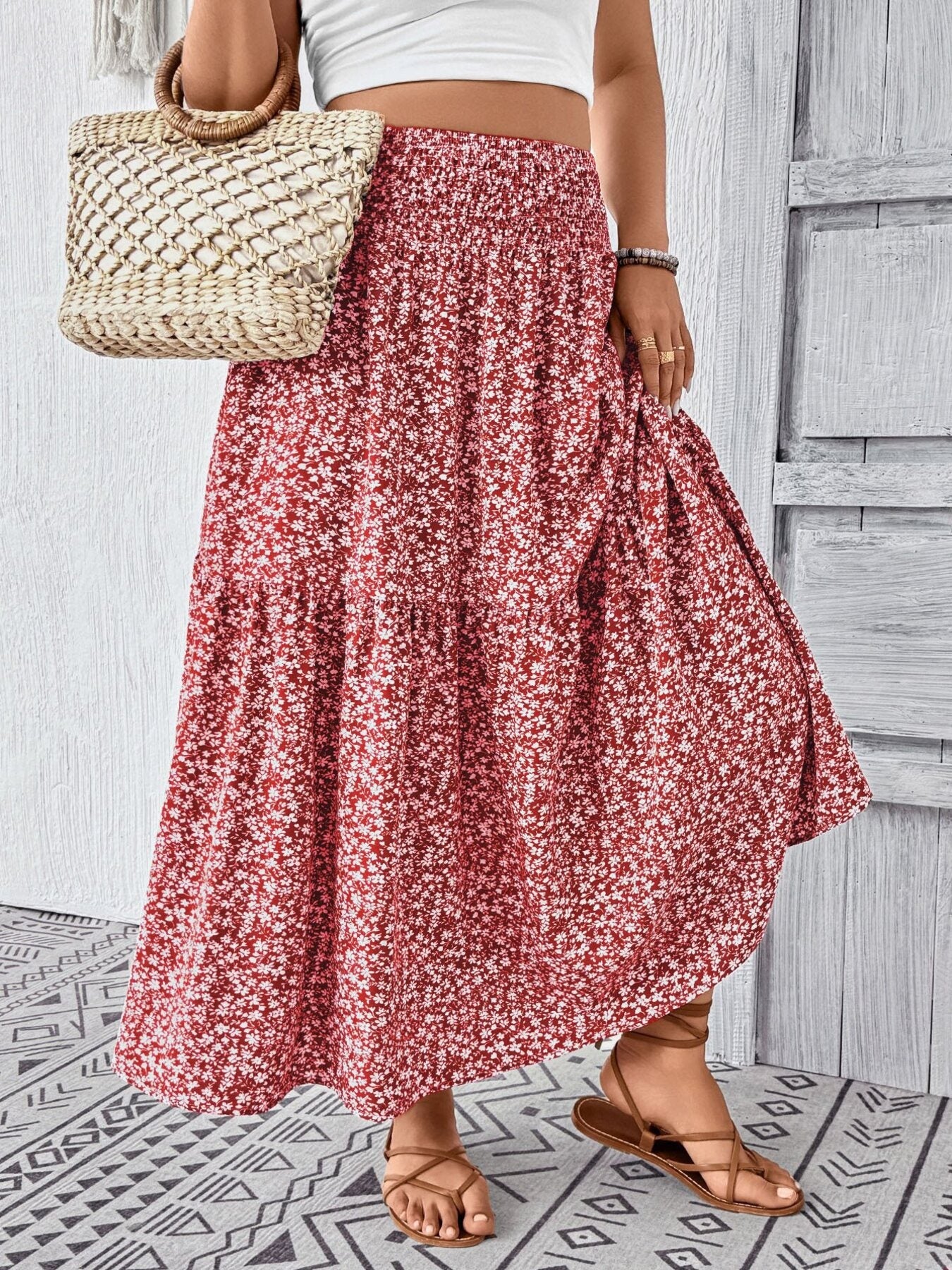 Charming floral print tiered maxi skirt with smocked waist, shown in red.