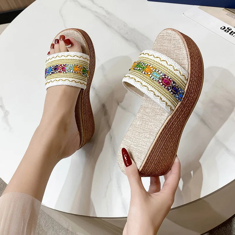 Embroidered platform wedge slides with colorful beads and white trim.