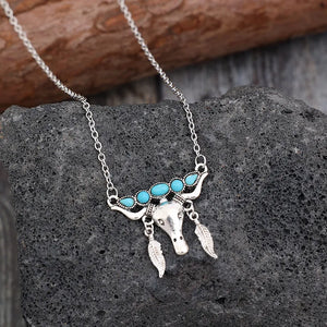 Silver necklace with turquoise bull head and feather charms