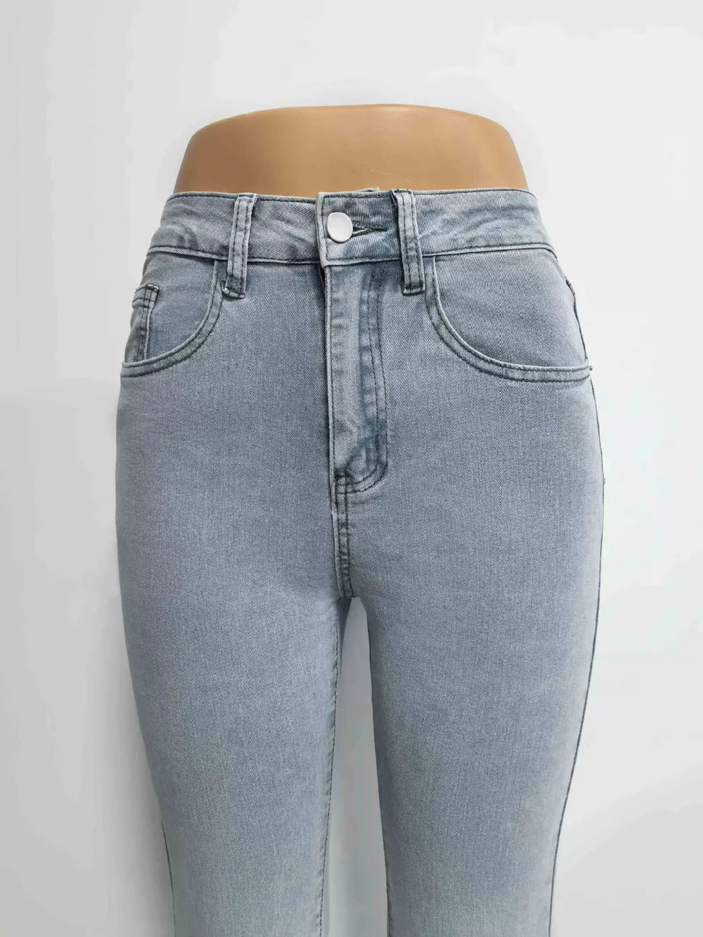 Light blue denim maternity jeans with pockets and a button closure.
