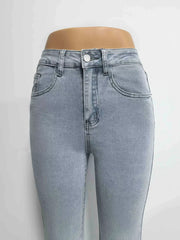 Light blue denim maternity jeans with pockets and a button closure.