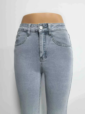 Light blue denim maternity jeans with pockets and a button closure.