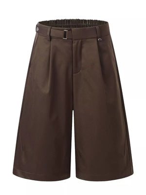 Brown pleated wide-leg capris with elastic waistband and buckle detail