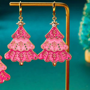 Christmas tree dangle earrings in blush pink with gold accents and green gem details.