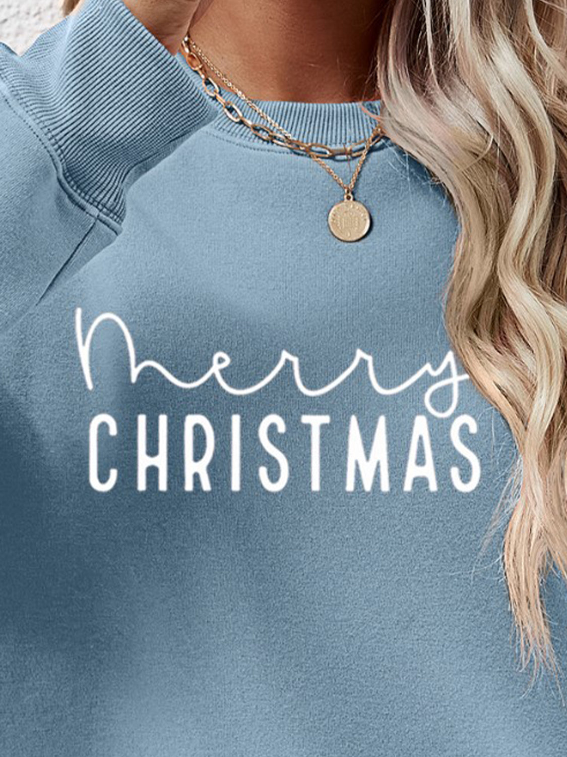 Misty Blue Merry Christmas graphic sweatshirt with crewneck and long sleeves.