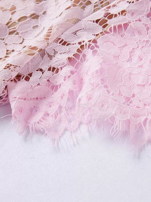 Powder floral lace dress detail with fringed hem.