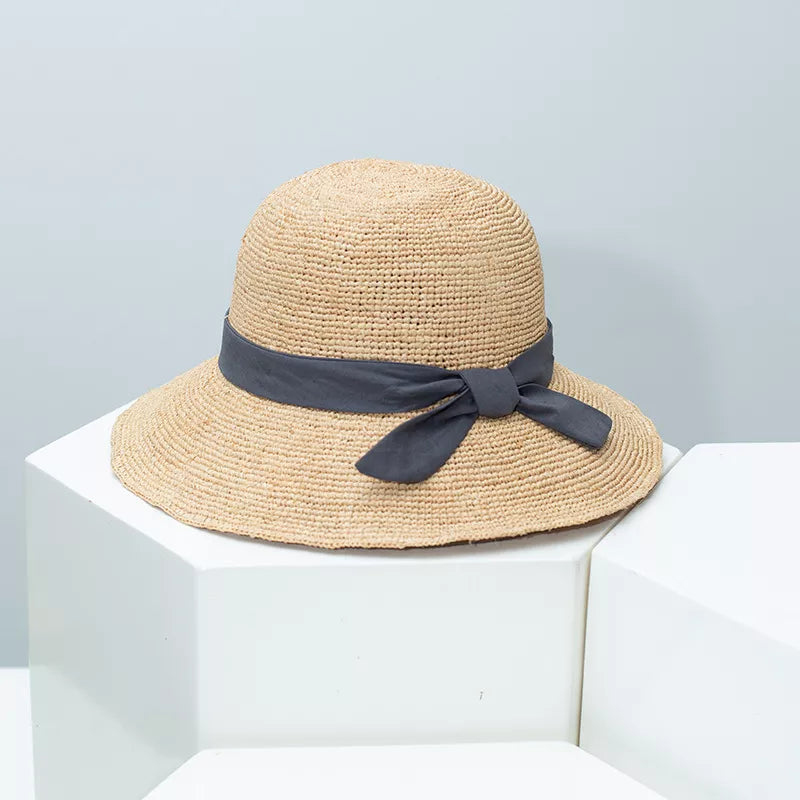 Chic wheat straw sun hat in natural with gray bow detail.