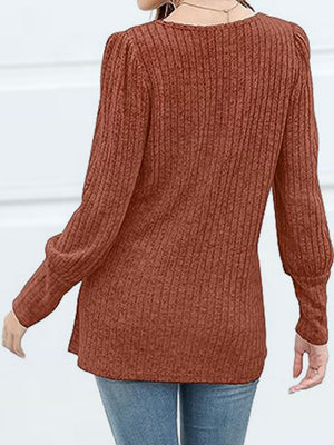 Ribbed knit blouse in Red Orange with puff sleeves and button detail.