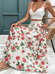 Elegant floral maxi skirt with red roses and green leaves on a white background, featuring pleats.