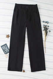 Black seamed front wide leg trousers with buttoned waist and pocket details.