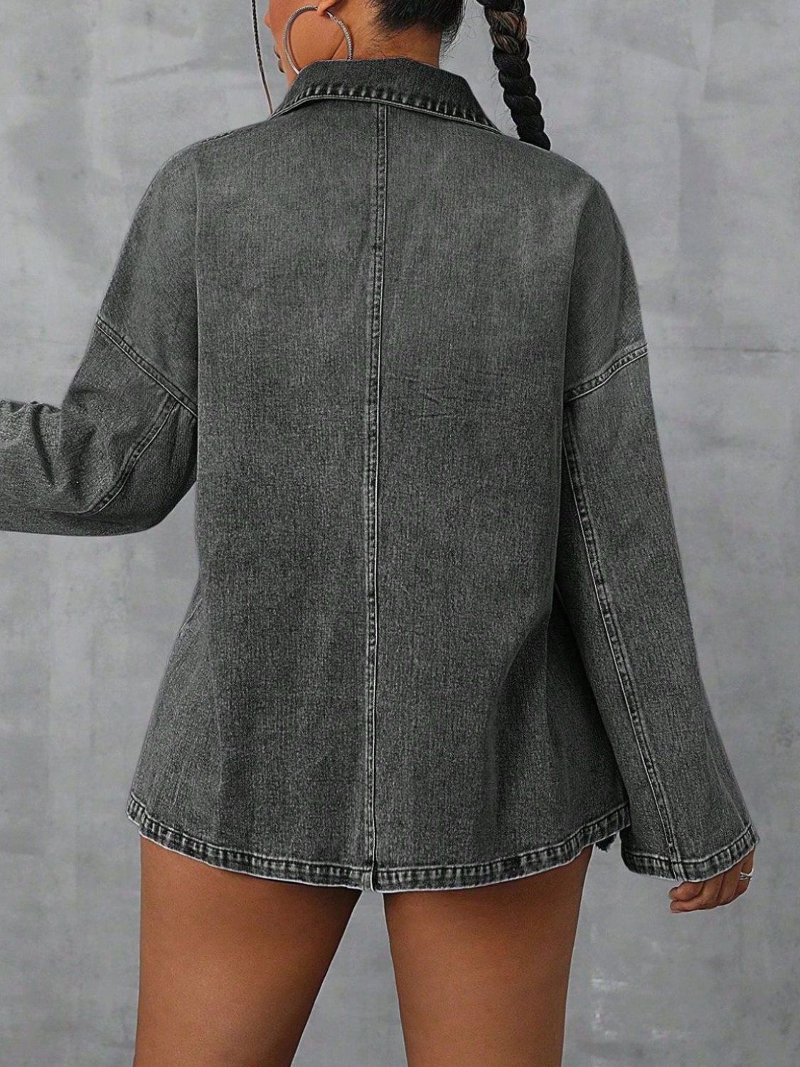Oversized dark wash denim polo shirt with collared neckline and long sleeves.