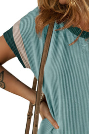 Ribbed tee dress in dusty blue with colorblock sleeves in teal and tan.