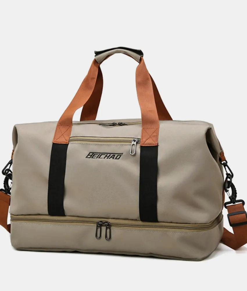 Khaki dual-compartment weekender bag with contrast black and orange straps and dual zipper bottom.
