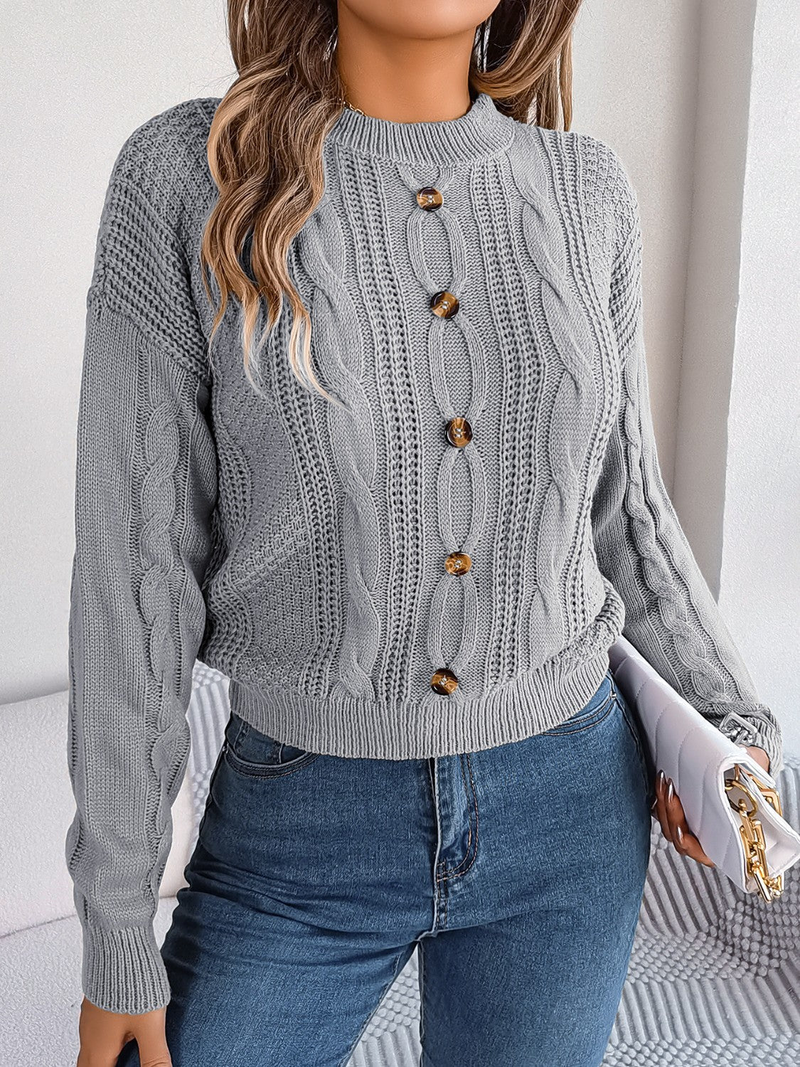 Charcoal cable knit button-up sweater with mock neck and tortoise buttons.