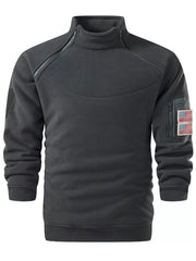 Gray fleece sweatshirt with mock neck, diagonal zipper, and flag patch pocket.