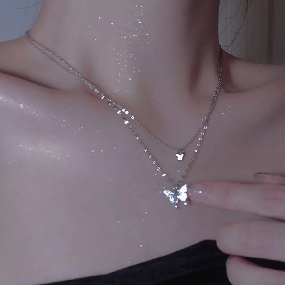 Elegant double-layer necklace with butterfly charms in white gold color.