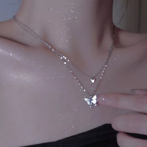 Elegant double-layer necklace with butterfly charms in white gold color.