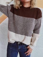 Colorblock textured knit pullover sweater with mock neck and long sleeves.