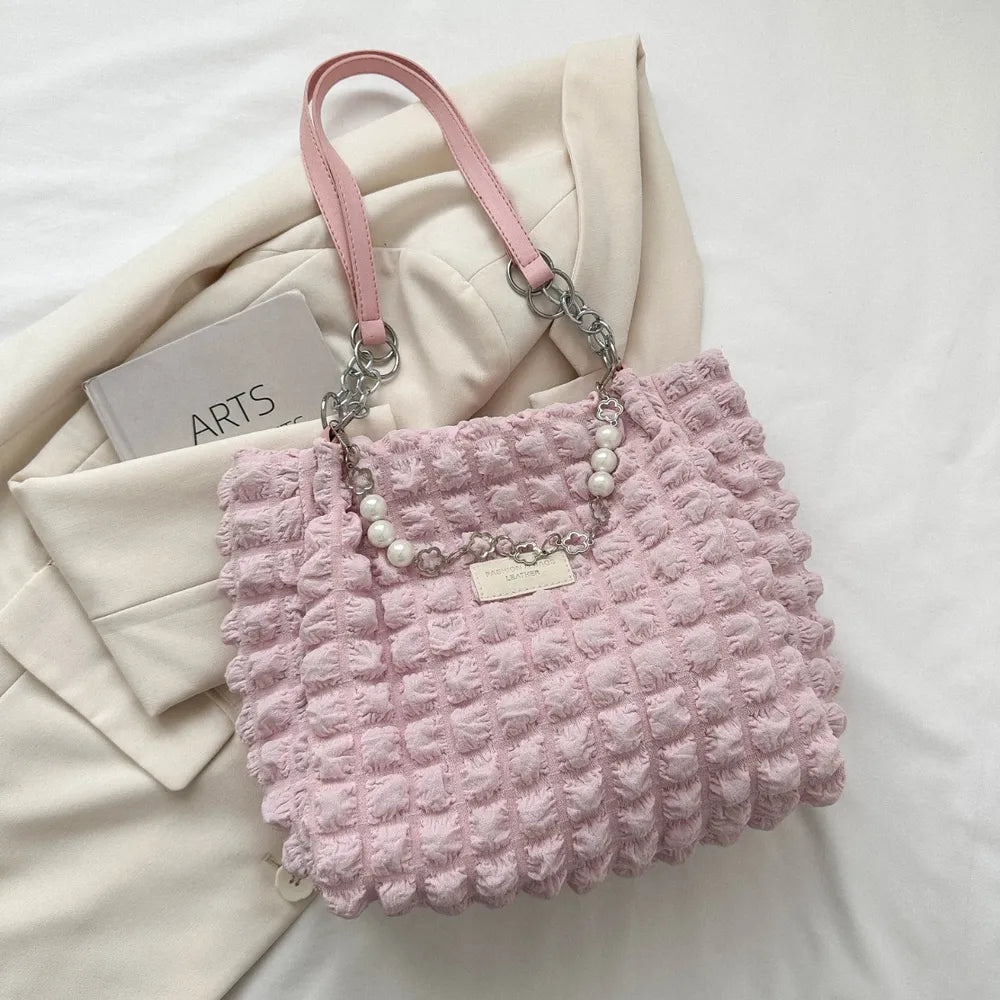 Blush pink textured grid shopper bag with pearl chain detail and chain straps.