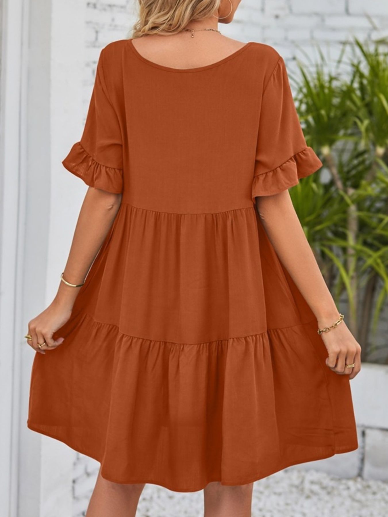 Caramel tiered mini dress with ruffled short sleeves and scoop neck.