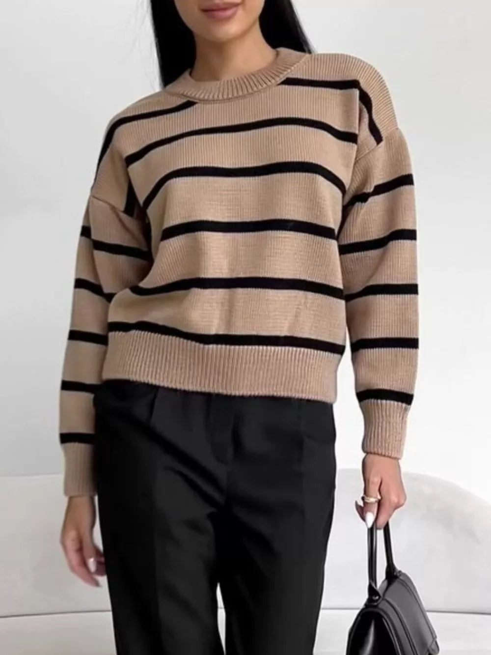 Classic striped knit sweater in taupe with black stripes, round neck, and long sleeves.