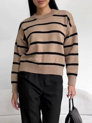 Classic striped knit sweater in taupe with black stripes, round neck, and long sleeves.