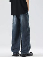 Oversized wide-leg jeans in blue denim with a drawstring waist and relaxed fit.