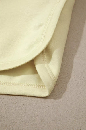 Light yellow mock neck two-piece set detail showing soft fabric and clean stitching.
