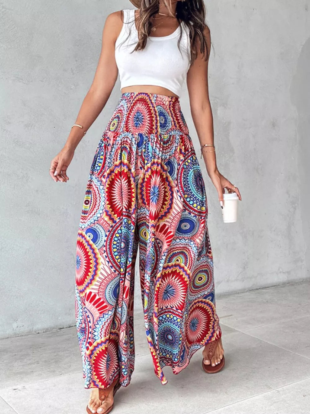 Bohemian print wide-leg pants with smocked waist in red, blue, and yellow pattern.