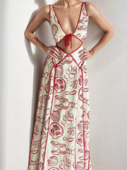 Maxi dress with oceanic print, cutout, and red trim.