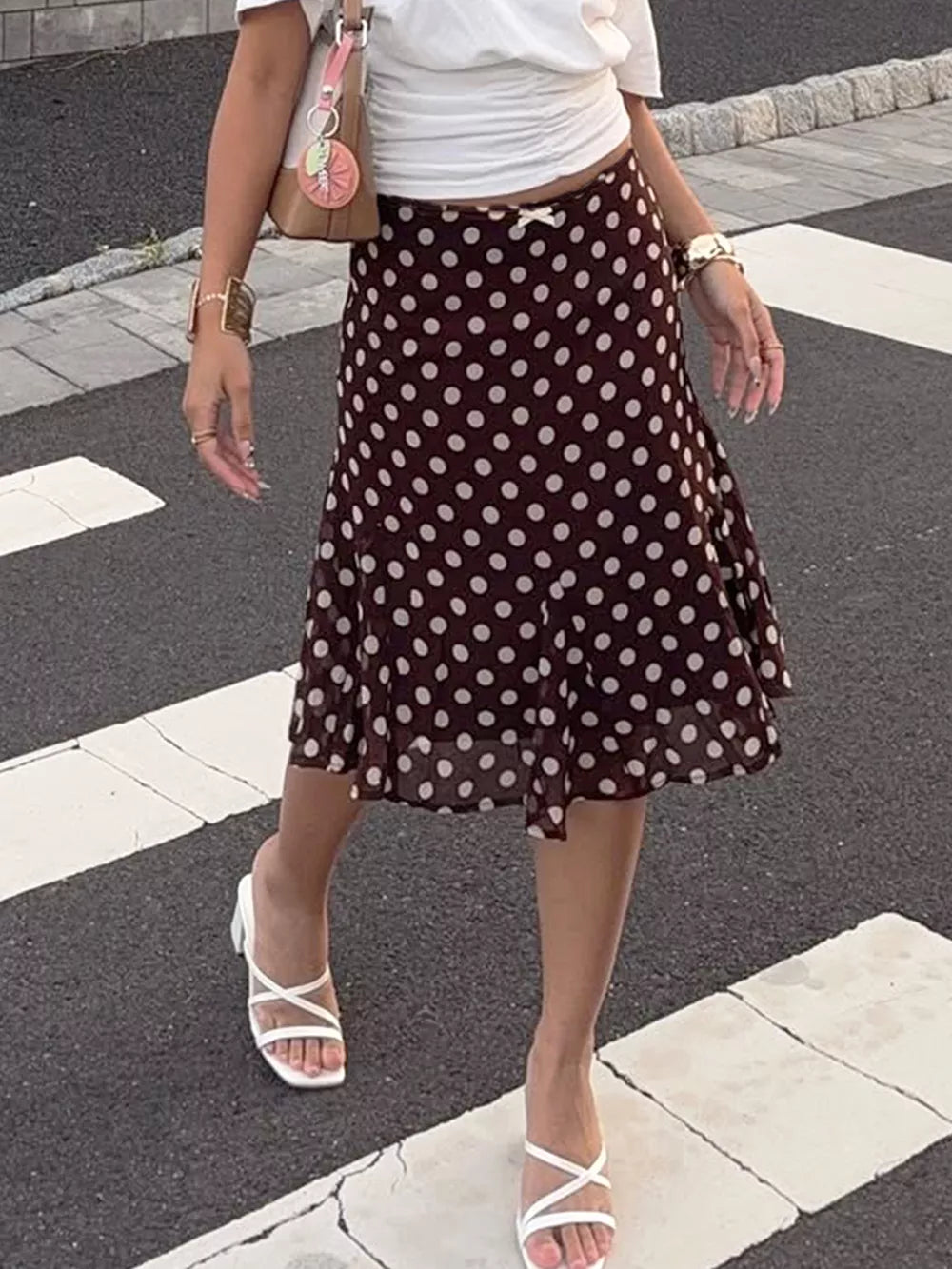 Dark brown polka dot A-line skirt with bow detail and ruffled hem