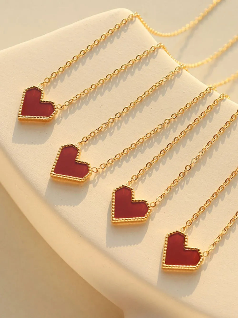 Gold chain necklace with a crimson heart pendant, 18K gold plated.